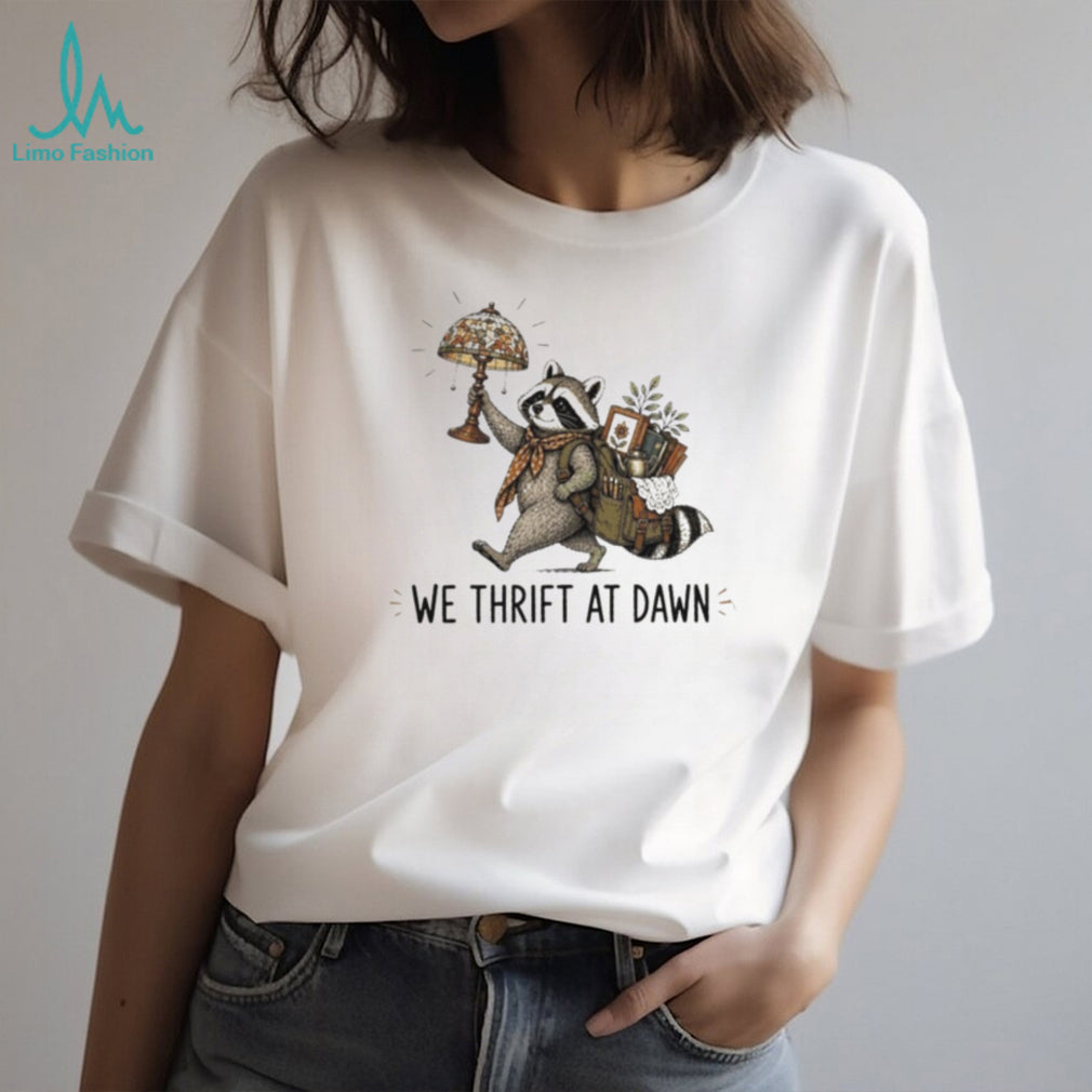 Raccoon carrying lamp and backpack items We Thrift at Dawn t shirt