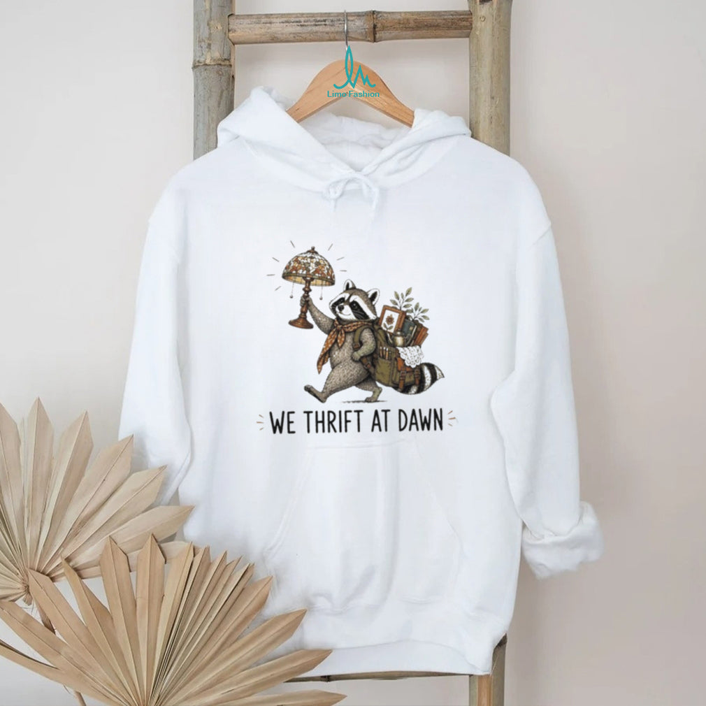 Raccoon carrying lamp and backpack items We Thrift at Dawn t shirt