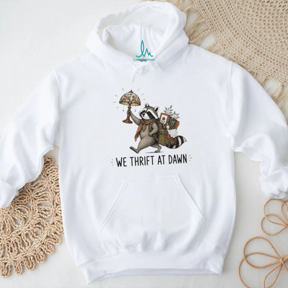 Raccoon carrying lamp and backpack items We Thrift at Dawn t shirt