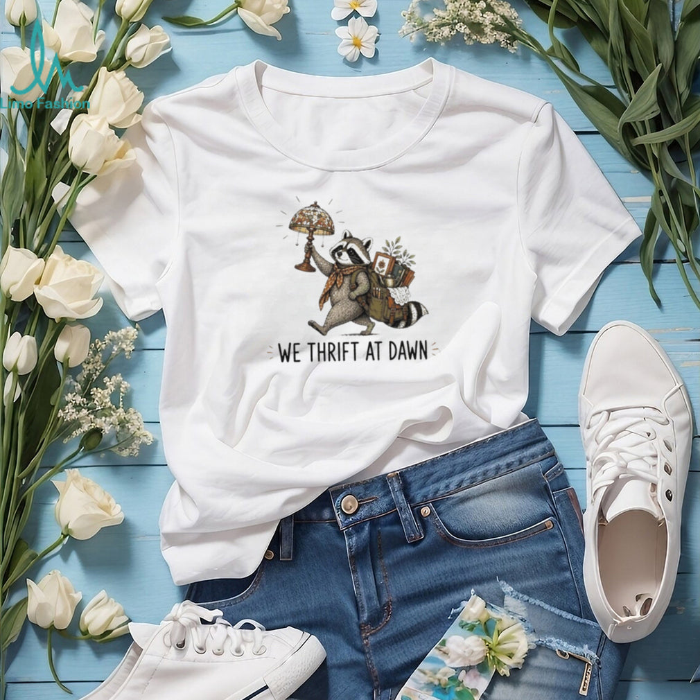 Raccoon carrying lamp and backpack items We Thrift at Dawn t shirt