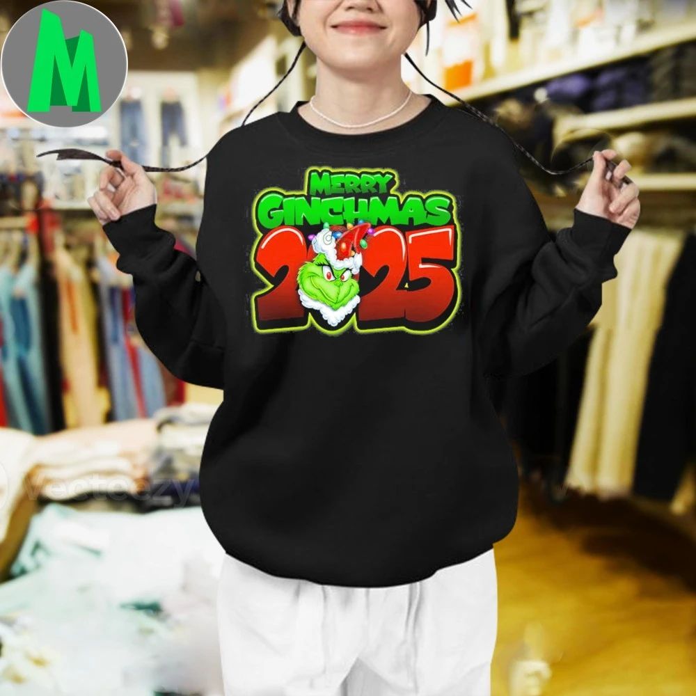 Merry Grinchmas 2025 The Grinch is wearing a Santa hat and Christmas lights Shirt