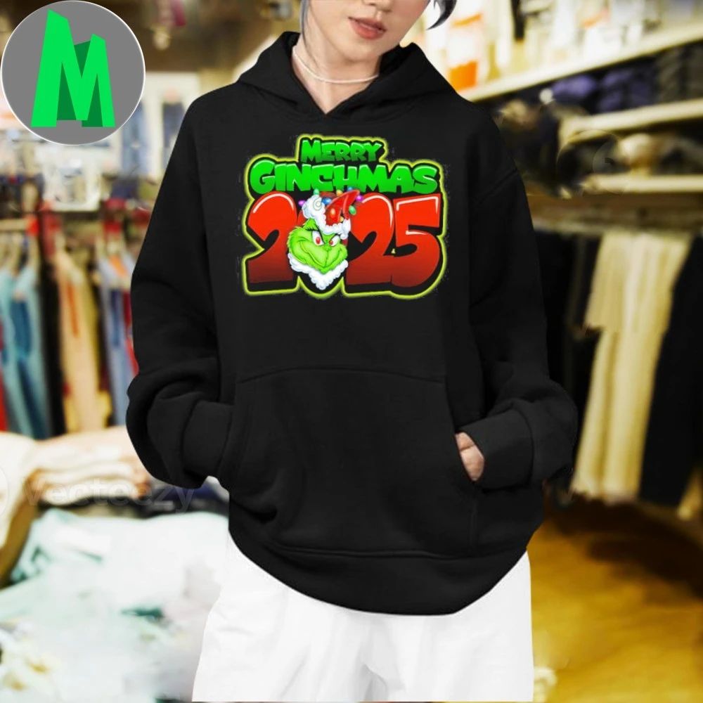 Merry Grinchmas 2025 The Grinch is wearing a Santa hat and Christmas lights Shirt